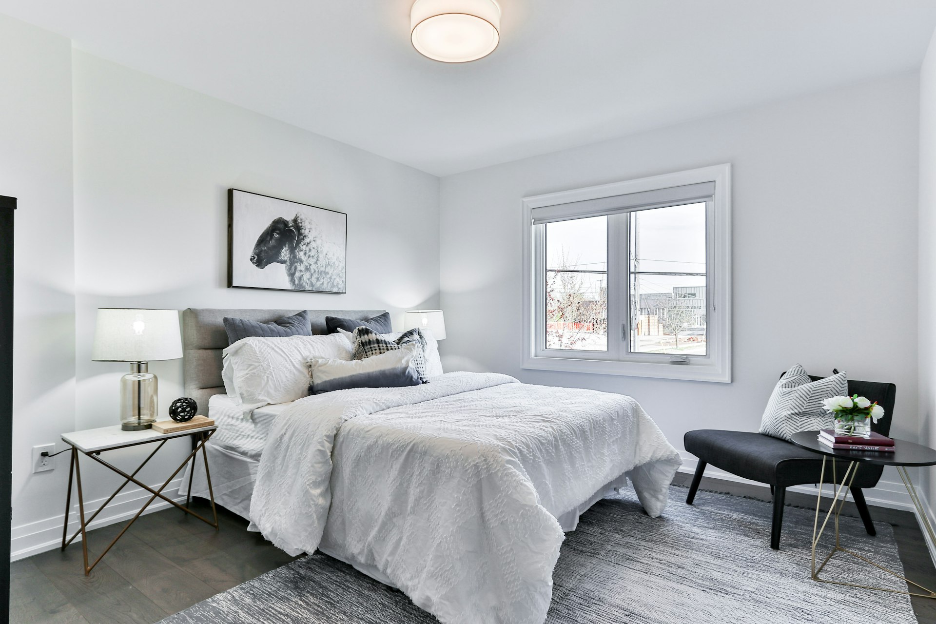 Cozy reading corner featuring a brown leather armchair, warm beige knitted throws, minimal aesthetic bedroom, 8k resolution, natural lighting, empty room, no people